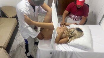 Married woman has her gynecological examination while her husband watches and enjoys it.