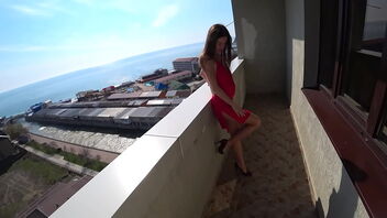 Public balcony sex with a Russian beauty in a red dress and heels.