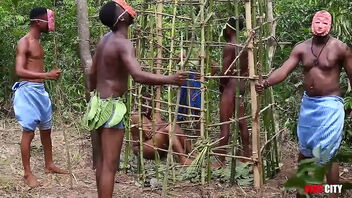 At a grand festival in West Africa, the king has sex with the most beautiful woman in a cage while his queen and others watch.