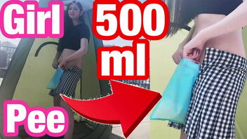 Japanese girl urinates while giving a handjob outdoors in 500ml portable toilet