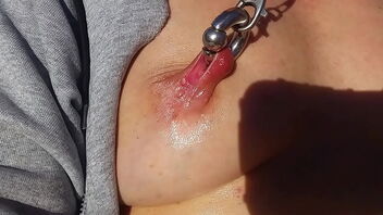 NipplePlay enthusiast, hot milf outdoors with vibrator and extreme nipple piercings