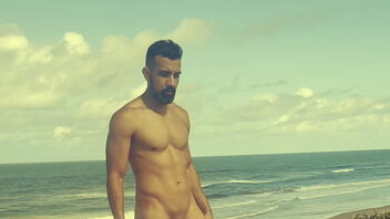 A skinny gay guy gets off on a nudist beach.