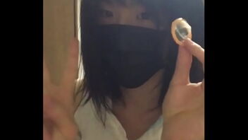 Gay Japanese man masturbates with a condom